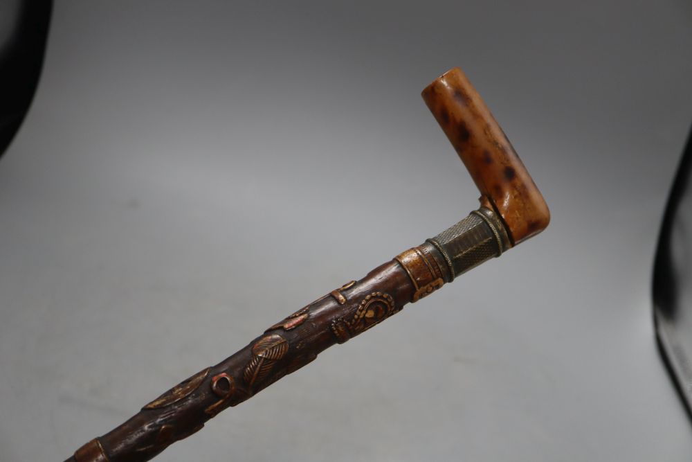 A Victorian walking stick, carved with a crown, an anchor and oak leaves, length 85cm
